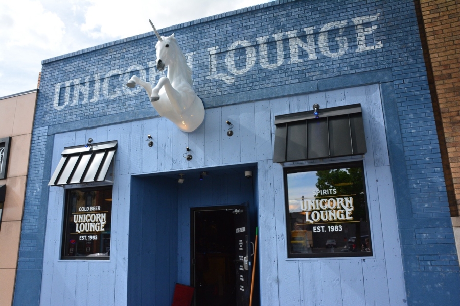 Unicorn Lounge storefront with unicorn head coming out of the wall